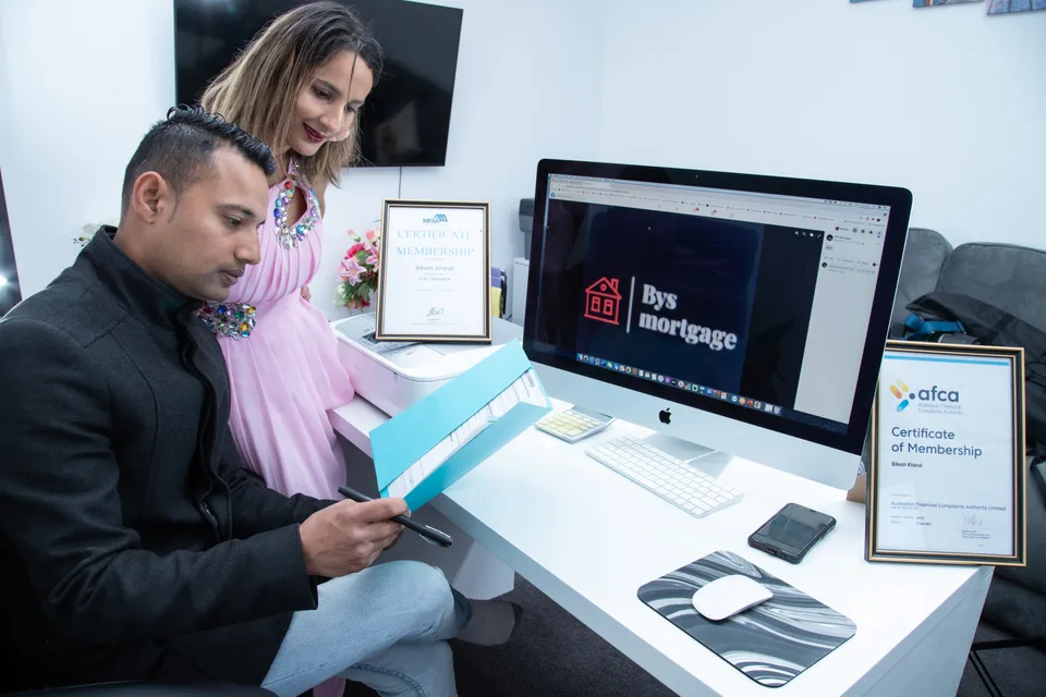 Two people discussing documents at a business consultation