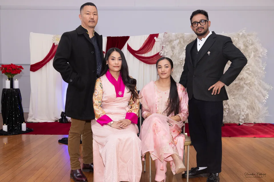 Four guests posing together at a formal celebration